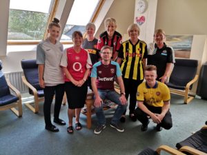 Illustration of team wearing football shirts as a charity fundraiser